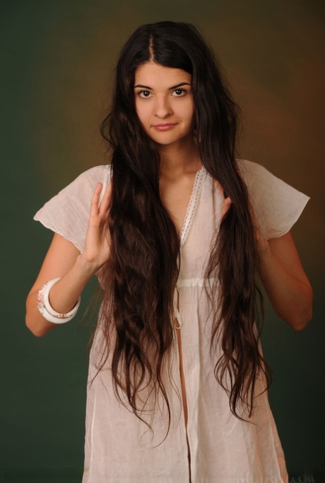 Nice teen Connie sports really long hair while naked in a wooden egg chair 41838808