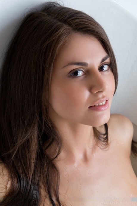 Pigtail adorned brunette Astrud A showing off trimmed twat in bathroom