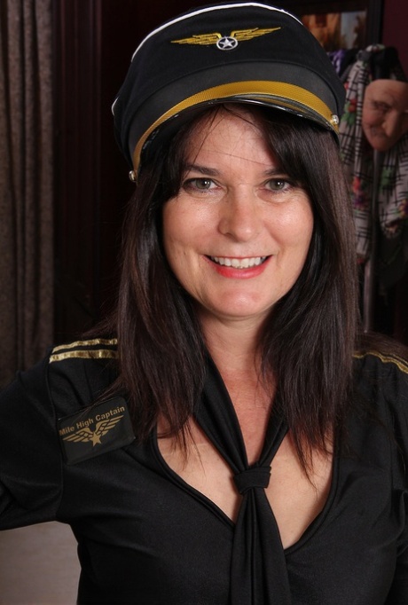 Mature woman Sherry Lee doffs pilot cap and uniform to model in the nude 91946277