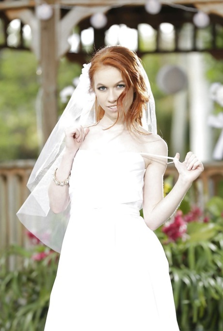 Redhead teen babe Dolly Little stripping off wedding dress outdoors